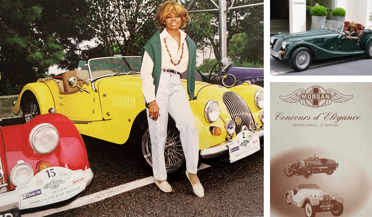 A woman standing next to an old car.